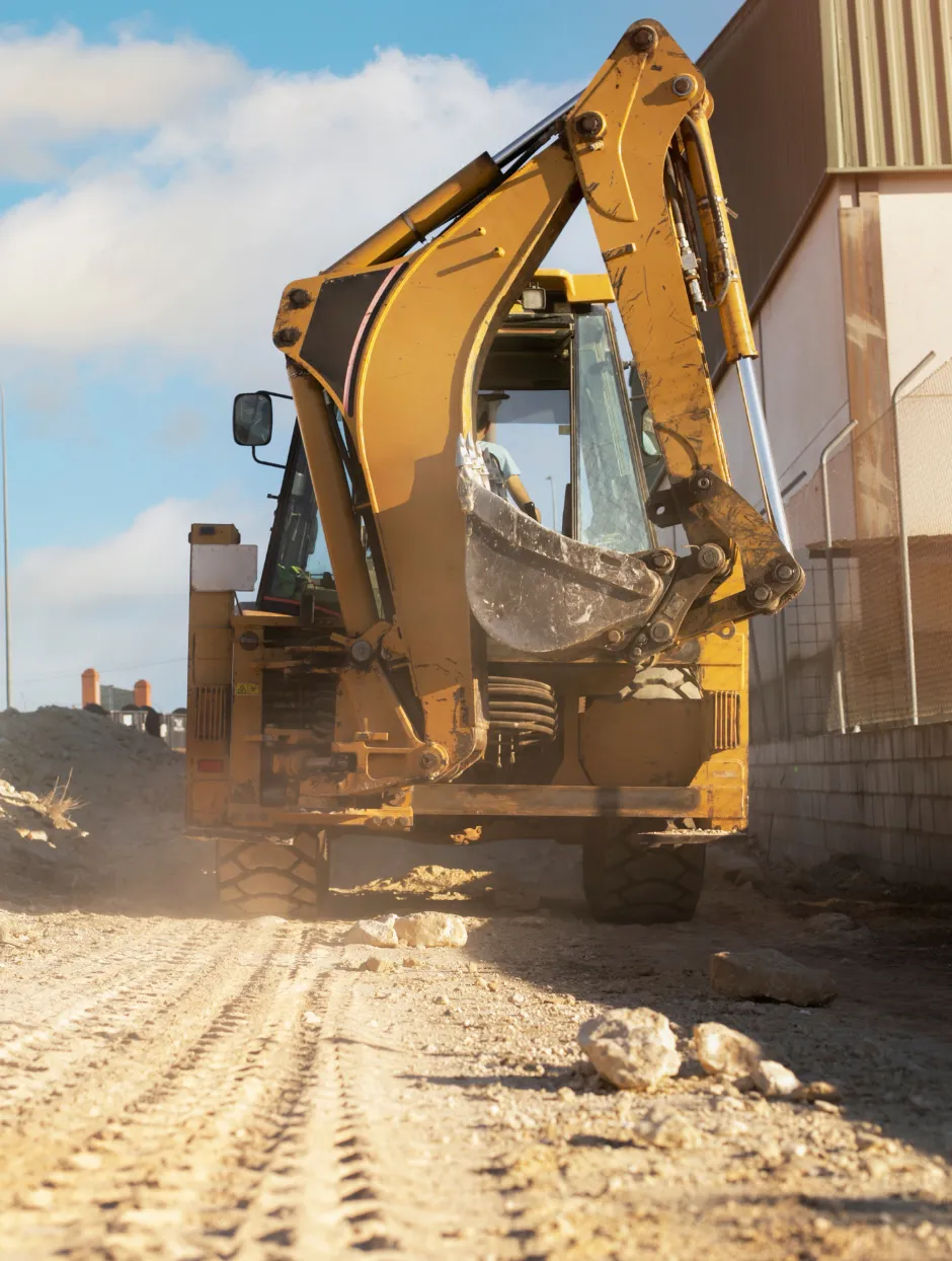 Heavy excavation equipment operating on a dirt construction site in Dallas TX for professional excavation services