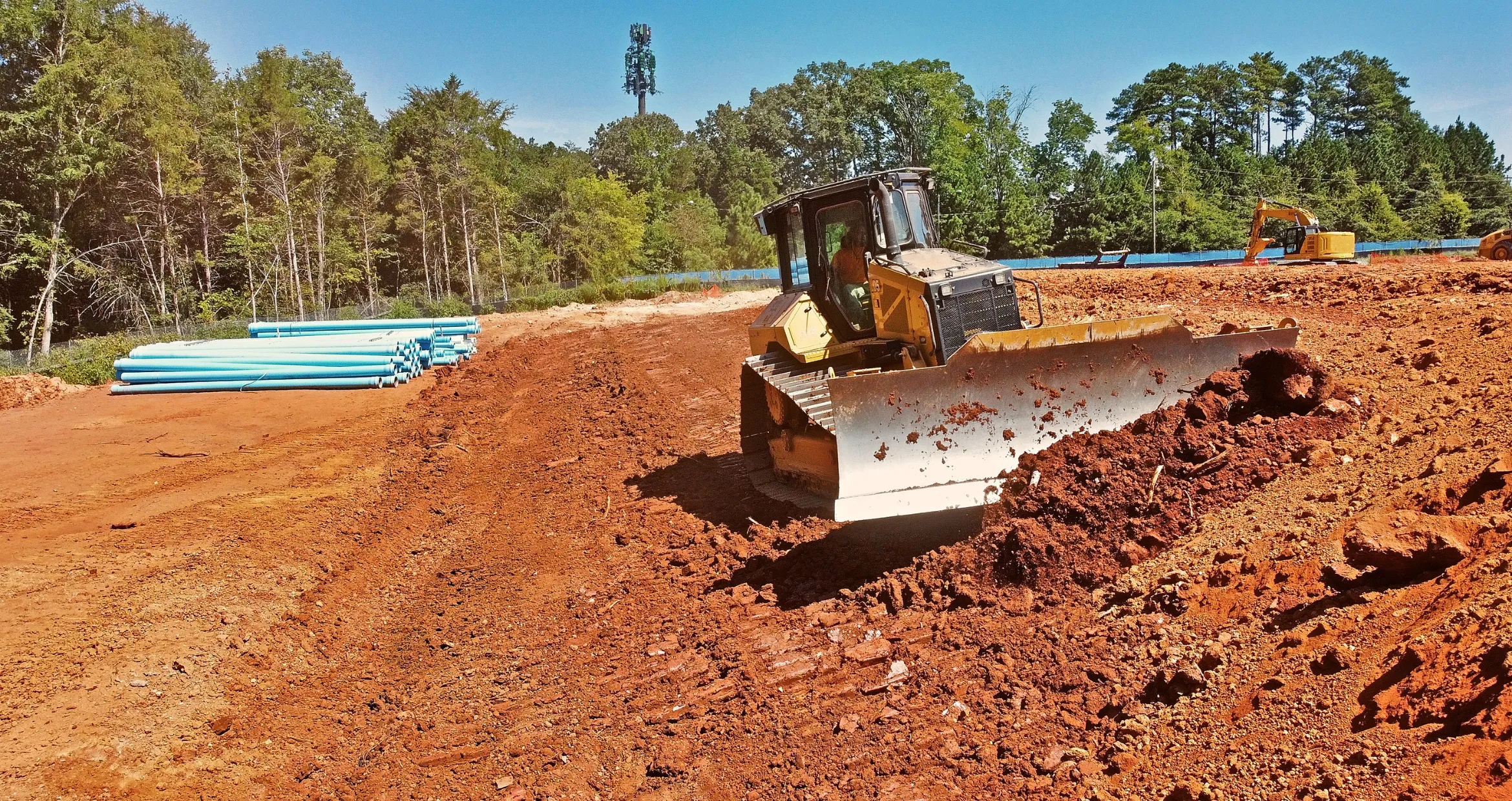 Large-scale earth moving project in Dallas using heavy machinery for soil relocation and site leveling